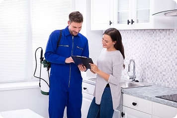 Pest Control Center Ottawa exterminator with a client